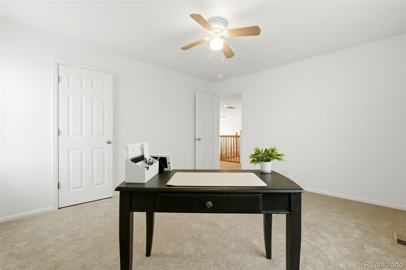 3033 East 108th Drive Northglenn, CO 80233 - Photo 25 of 50 a view of a workspace with furniture