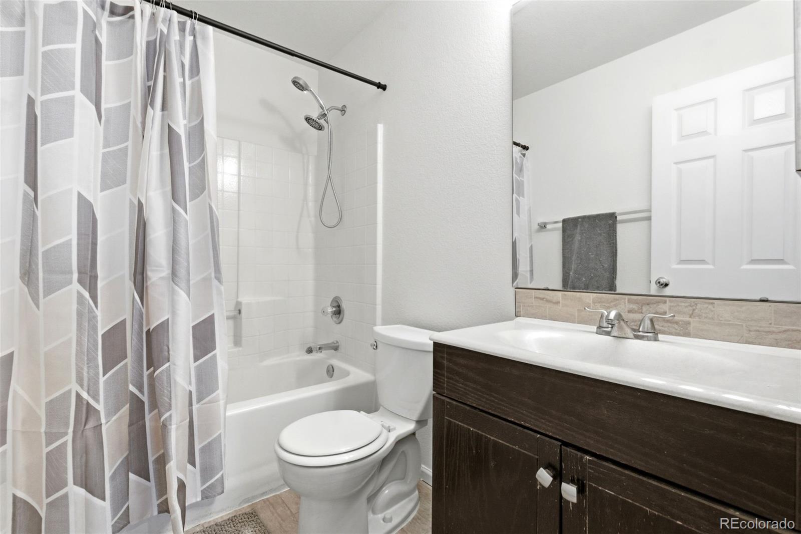 3033 East 108th Drive Northglenn, CO 80233 - Photo 27 of 50 a bathroom with a sink and a mirror