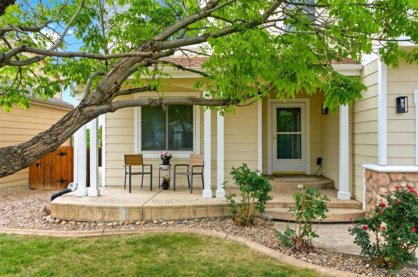 3033 East 108th Drive Northglenn, CO 80233 - Photo 3 of 50 a front view of a house with fountain and outdoor seating