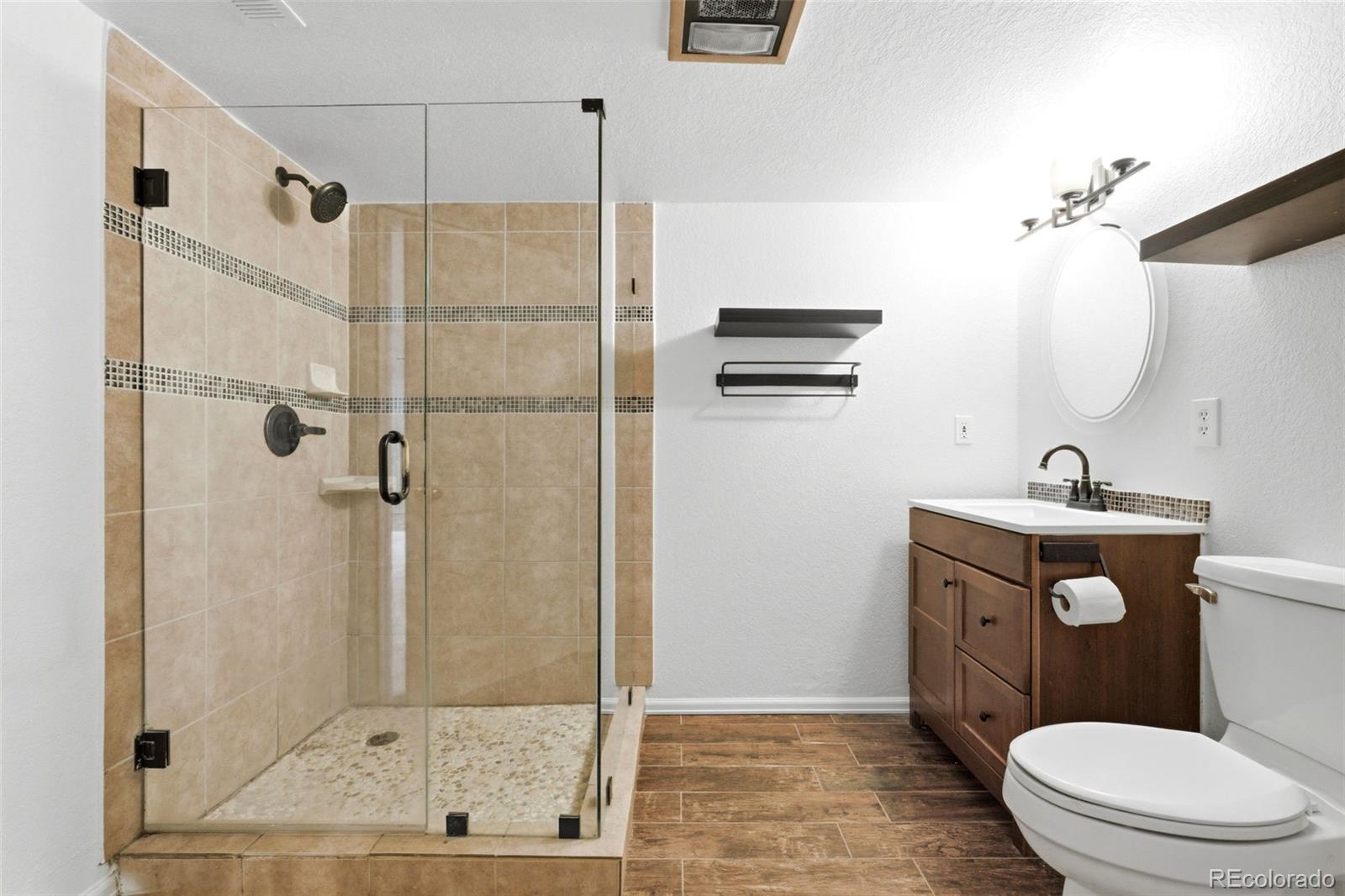 3033 East 108th Drive Northglenn, CO 80233 - Photo 32 of 50 a bathroom with a sink a toilet and shower