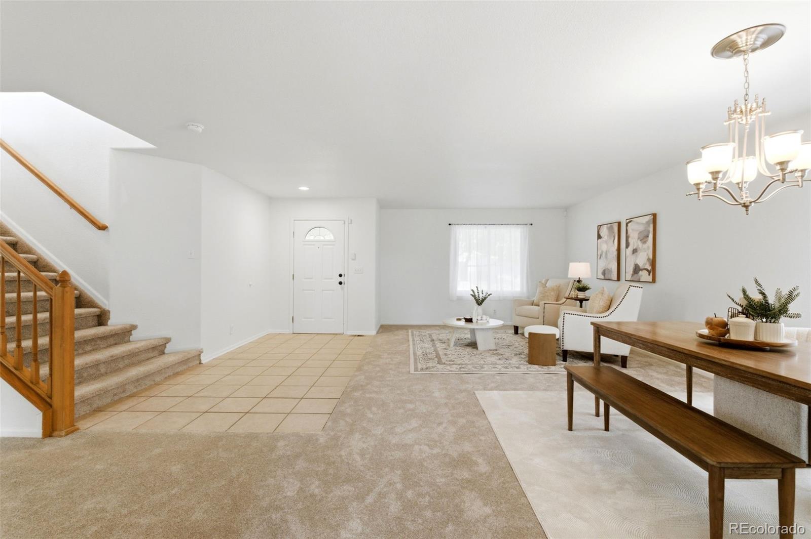 3033 East 108th Drive Northglenn, CO 80233 - Photo 35 of 50 a spacious bedroom with a bed and a chandelier