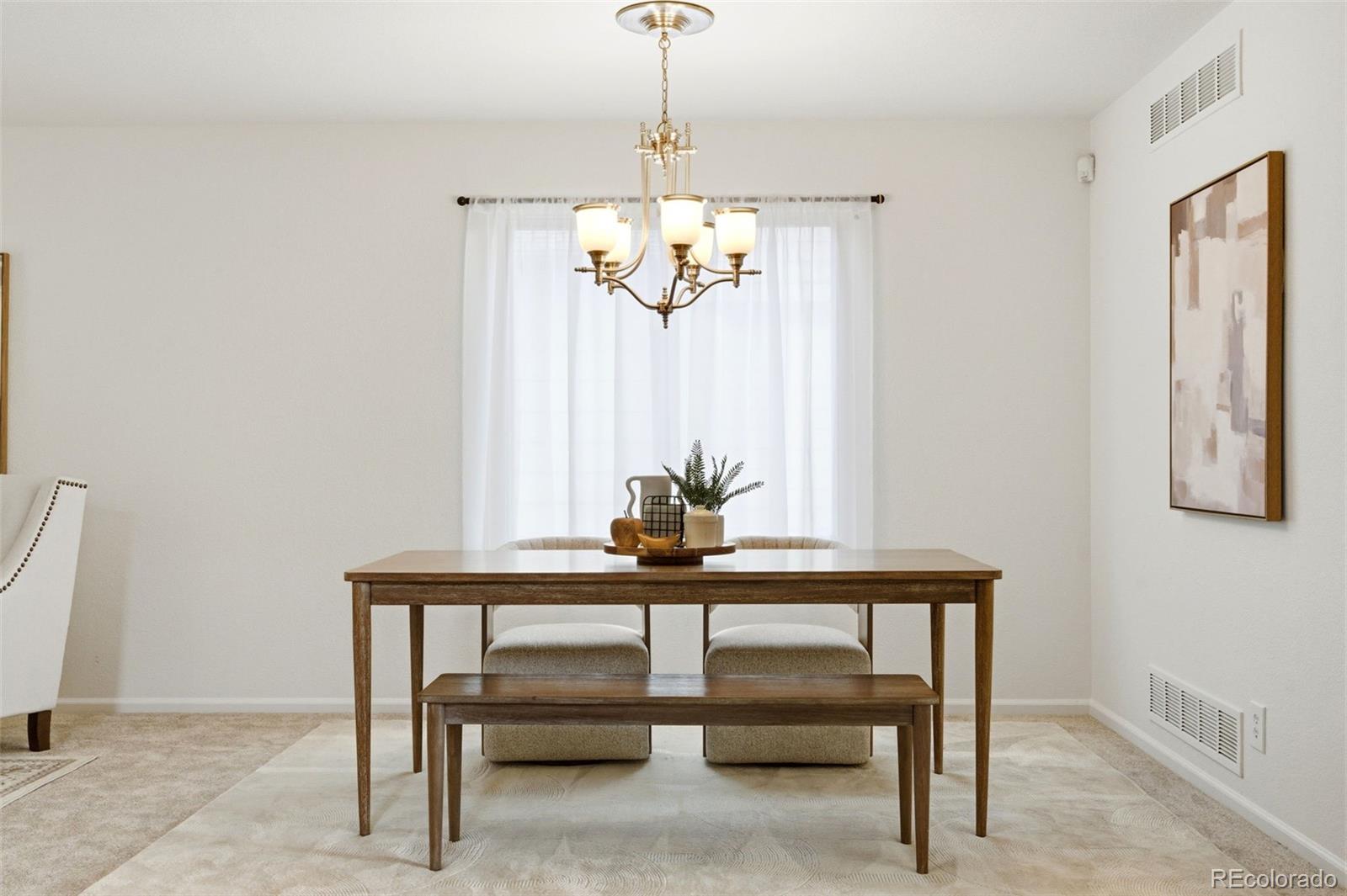 3033 East 108th Drive Northglenn, CO 80233 - Photo 39 of 50 a view of a dining room with furniture window and wooden floor