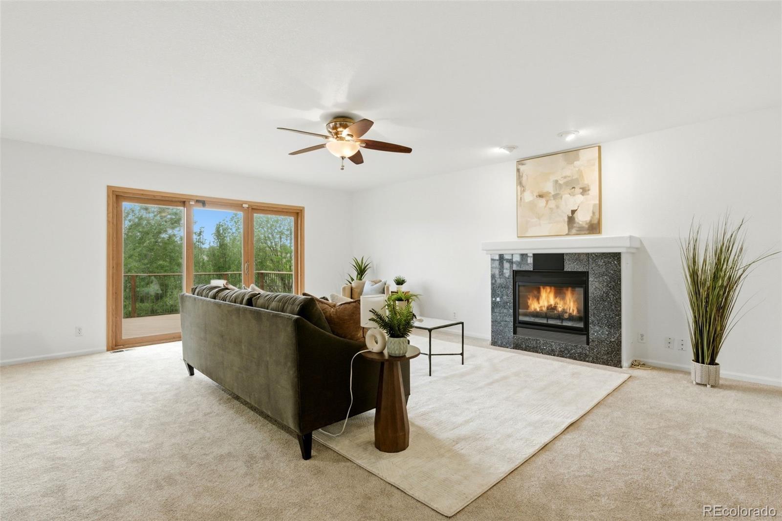 3033 East 108th Drive Northglenn, CO 80233 - Photo 40 of 50 a living room with furniture and a fireplace