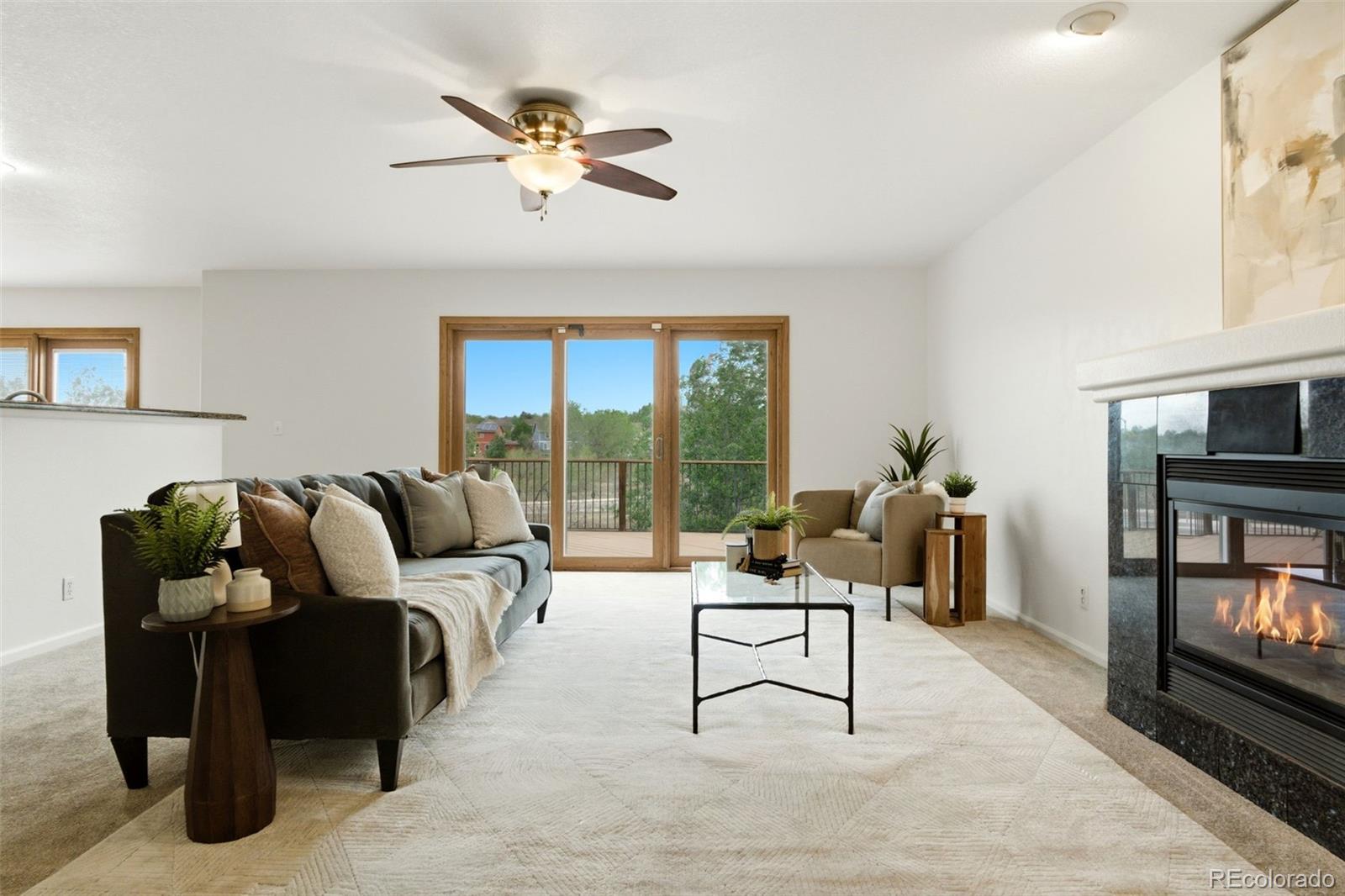 3033 East 108th Drive Northglenn, CO 80233 - Photo 4 of 50 a living room with furniture and a floor to ceiling window