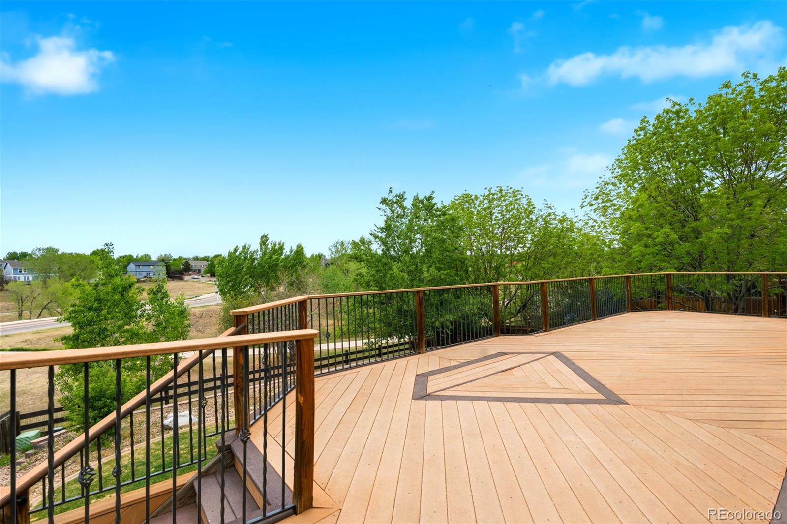 3033 East 108th Drive Northglenn, CO 80233 - Photo 42 of 50 a view of a balcony with wooden floor and fence