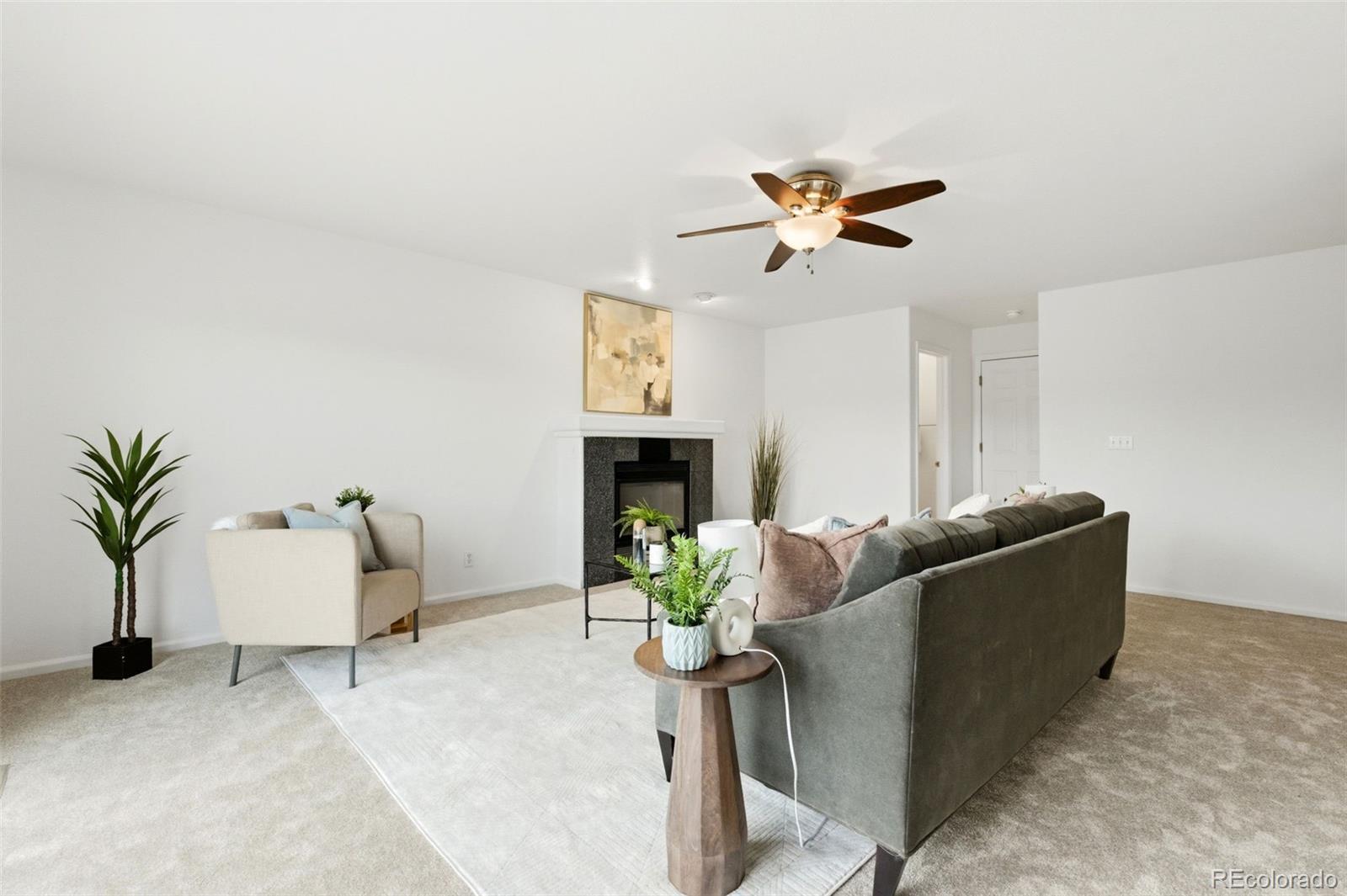3033 East 108th Drive Northglenn, CO 80233 - Photo 6 of 50 a living room with furniture and a chandelier
