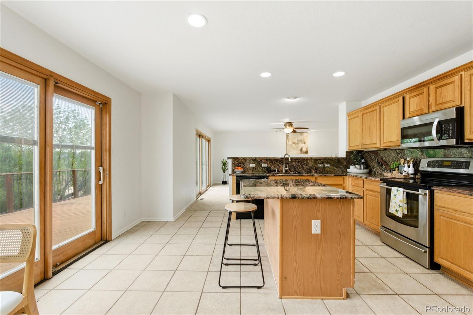 3033 East 108th Drive Northglenn, CO 80233 - Photo 8 of 50 a kitchen with a stove a sink and a refrigerator