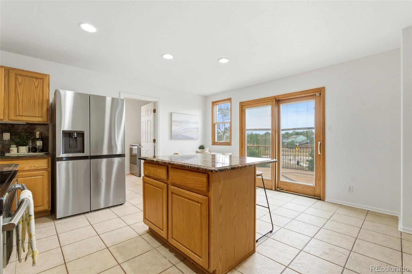 3033 East 108th Drive Northglenn, CO 80233 - Photo 10 of 50 a kitchen with stainless steel appliances granite countertop a refrigerator and a stove top oven