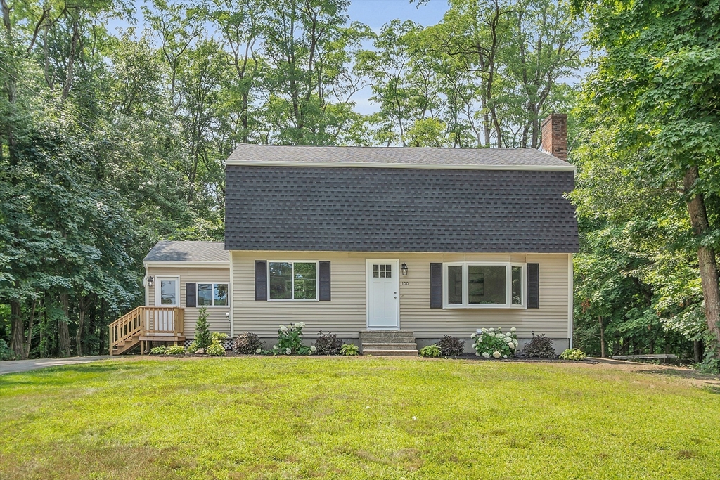 100 Dunstable Road North Chelmsford, MA 01863 - Photo 1 of 30 a house that has a big yard with plants and large trees