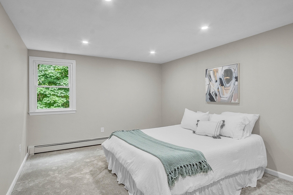 100 Dunstable Road North Chelmsford, MA 01863 - Photo 17 of 30 a bedroom with a bed and a painting on the wall