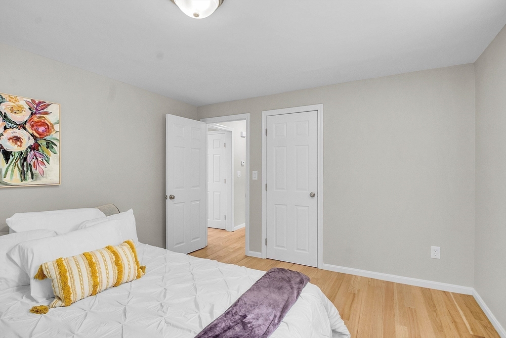 100 Dunstable Road North Chelmsford, MA 01863 - Photo 9 of 30 a bedroom with a bed and painting on the wall