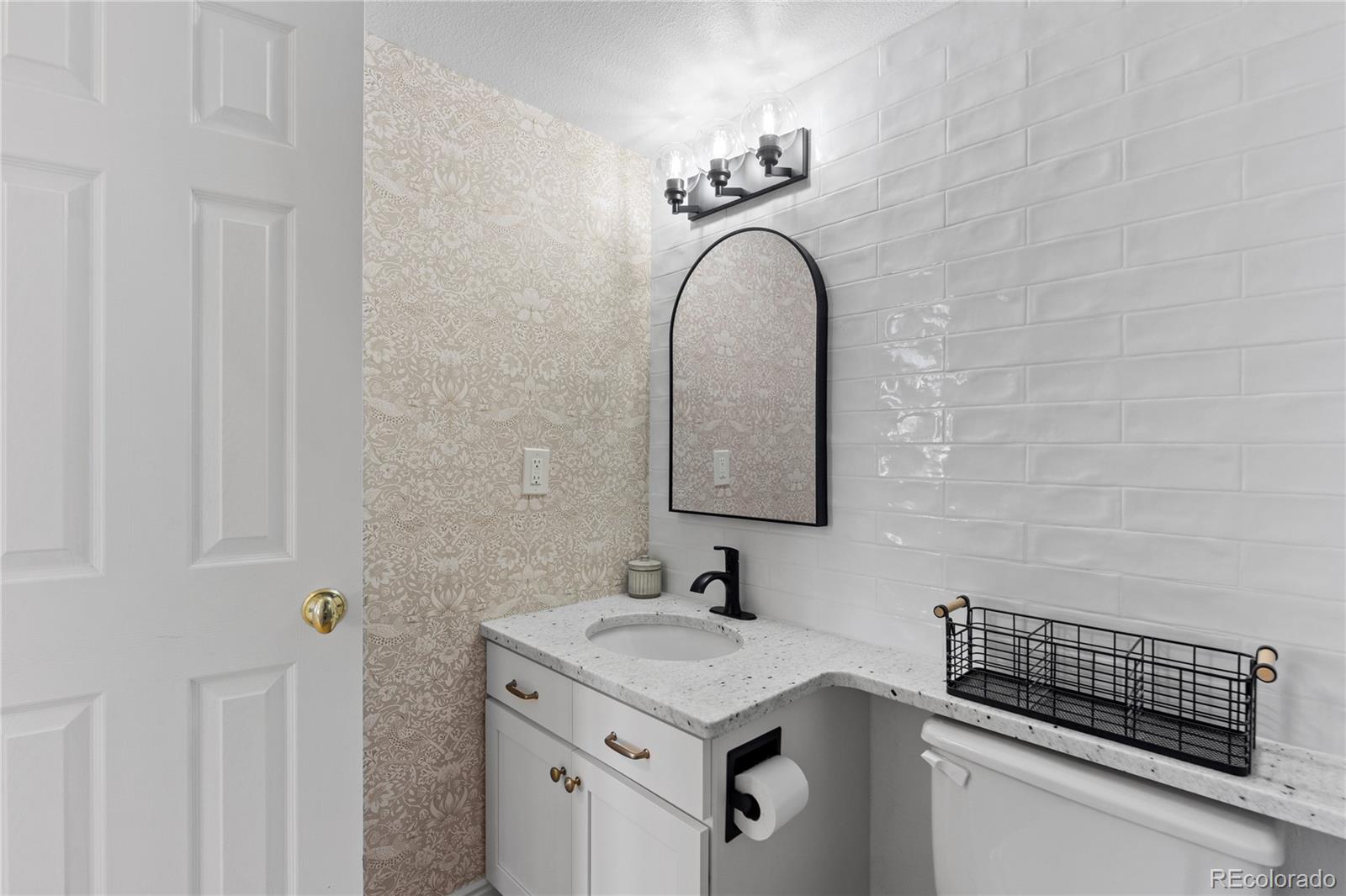 9362 Cornell Circle Highlands Ranch, CO 80130 - Photo 21 of 44 a bathroom with a granite countertop sink and a mirror