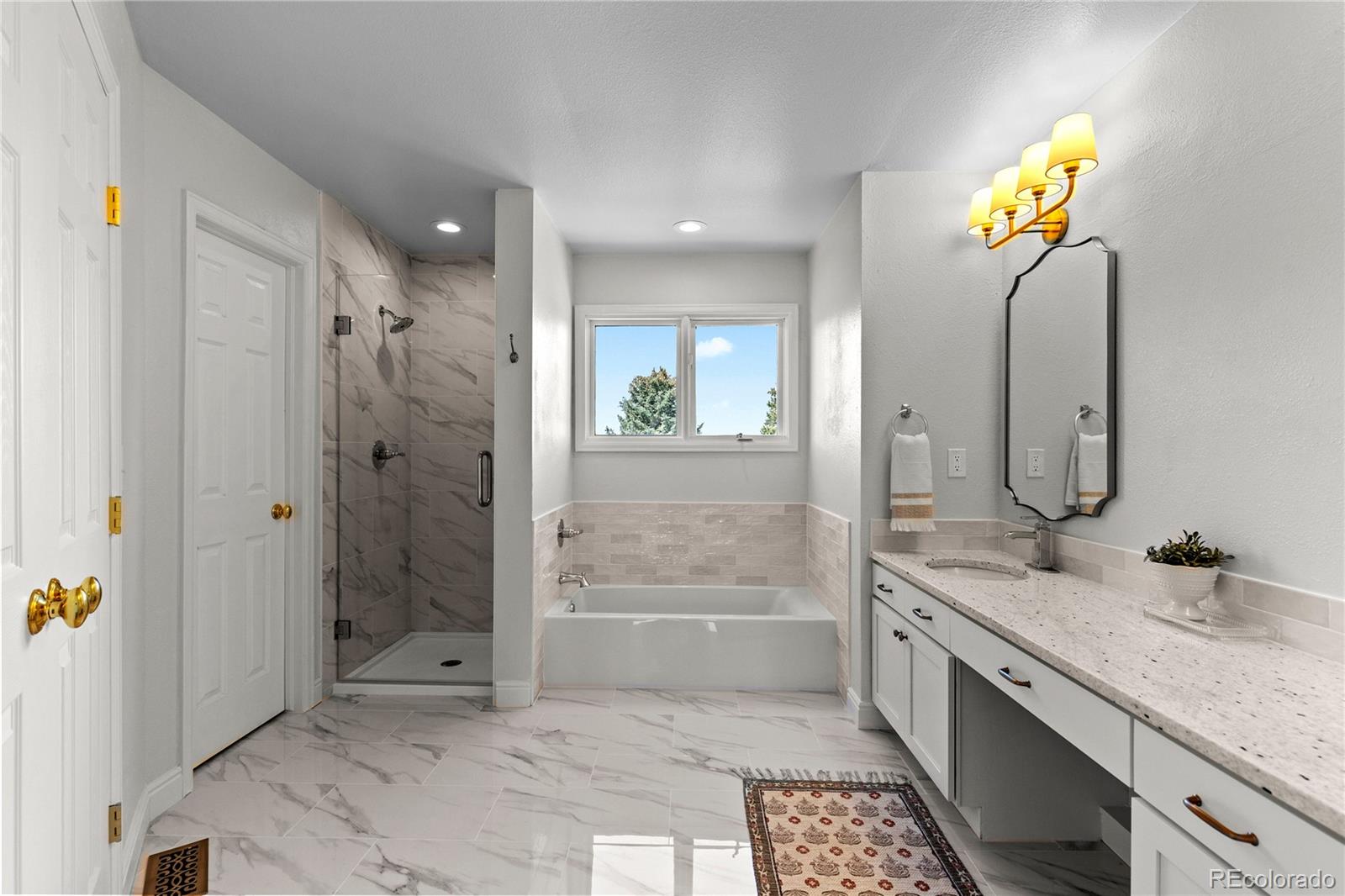9362 Cornell Circle Highlands Ranch, CO 80130 - Photo 27 of 44 a bathroom with a granite countertop sink a toilet and shower