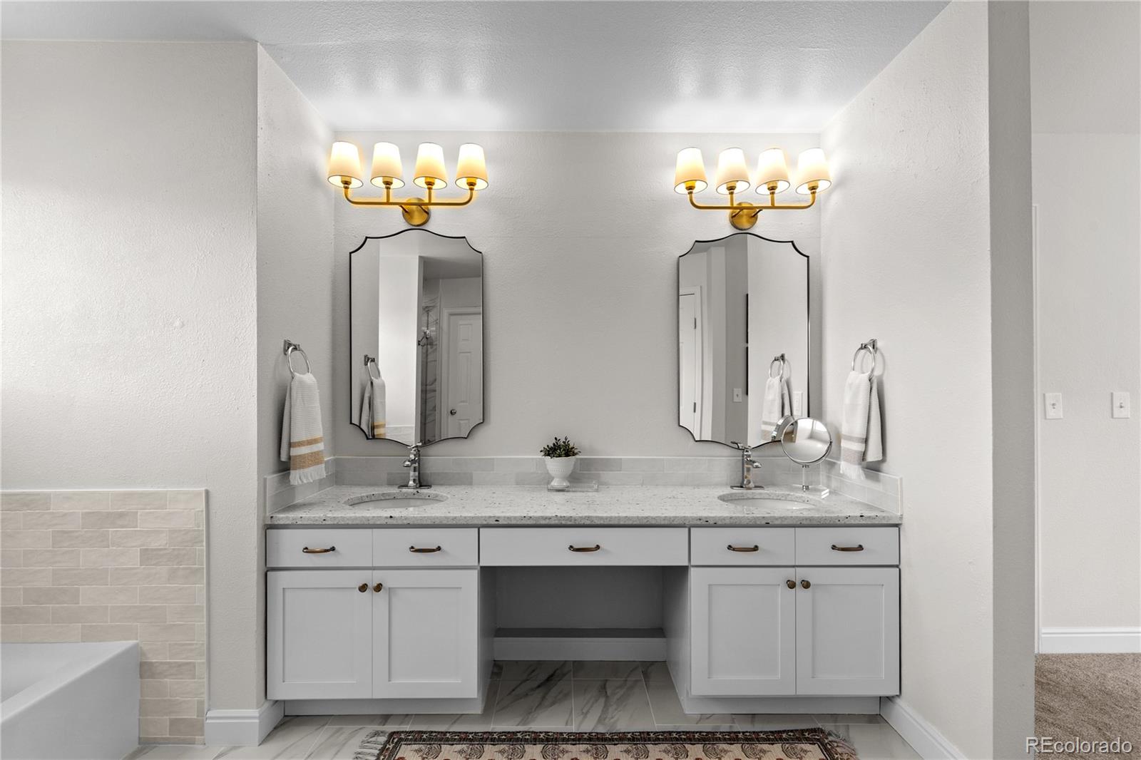 9362 Cornell Circle Highlands Ranch, CO 80130 - Photo 28 of 44 a bathroom with double vanity sinks and a mirror
