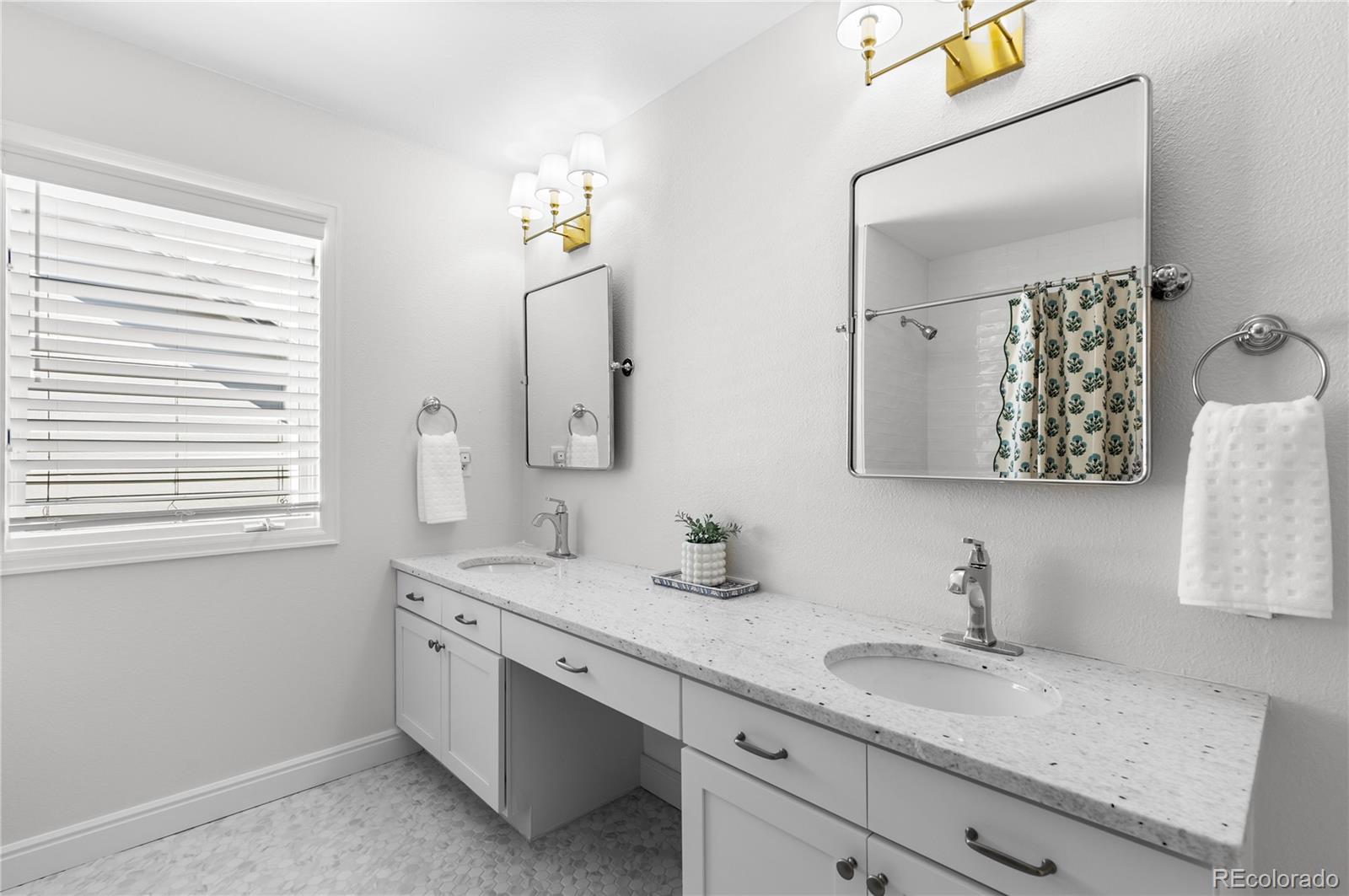 9362 Cornell Circle Highlands Ranch, CO 80130 - Photo 33 of 44 a bathroom with a granite countertop sink and a mirror