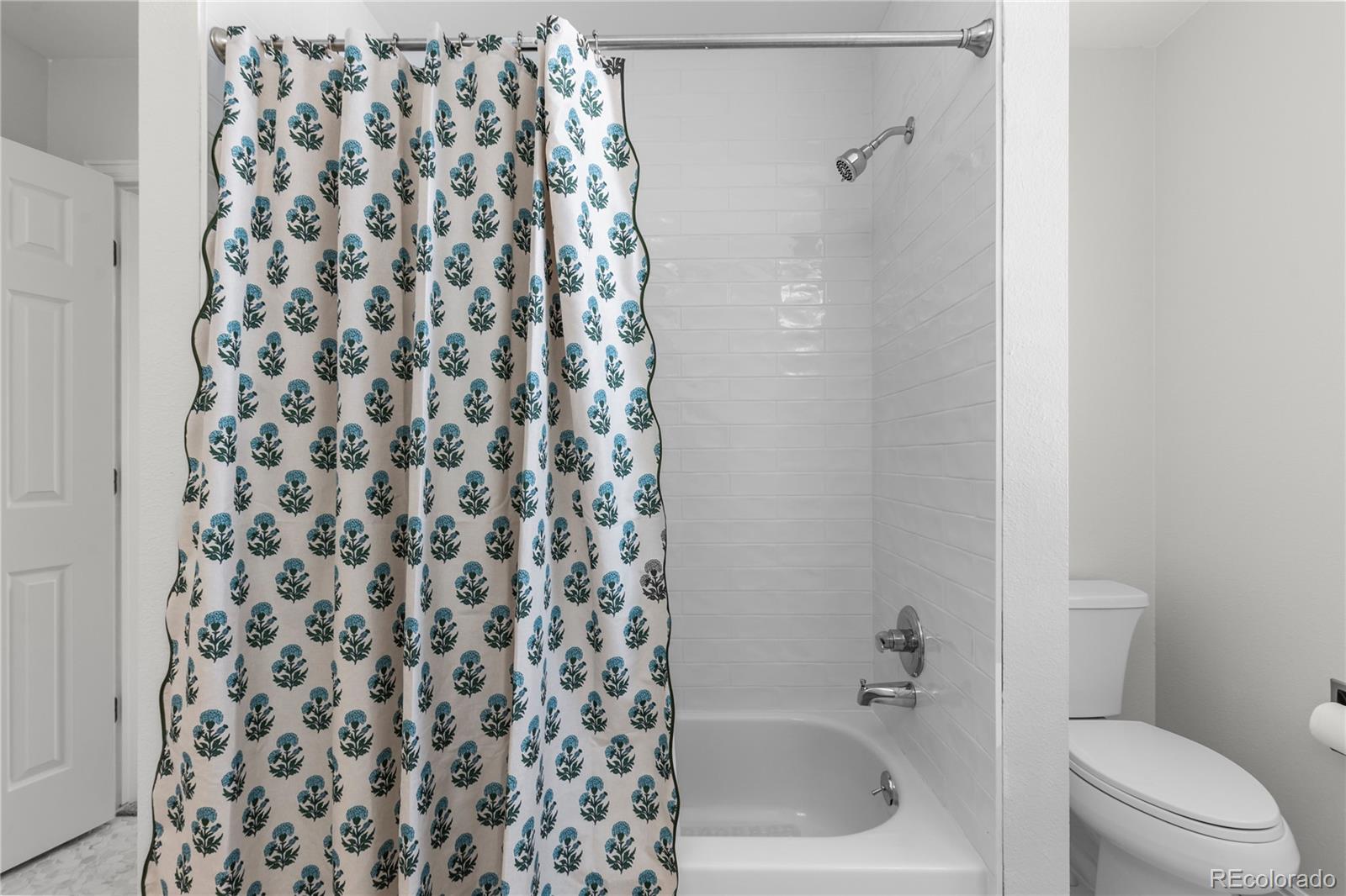 9362 Cornell Circle Highlands Ranch, CO 80130 - Photo 35 of 44 a bathroom with a bathtub and a shower curtain