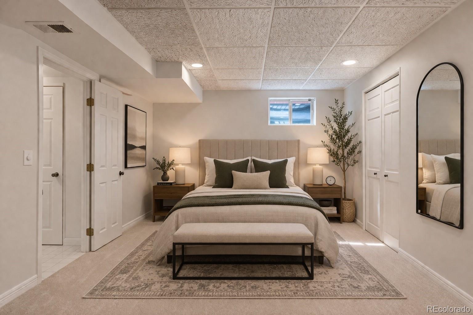 9362 Cornell Circle Highlands Ranch, CO 80130 - Photo 38 of 44 a spacious bedroom with a bed a mirror and lamp