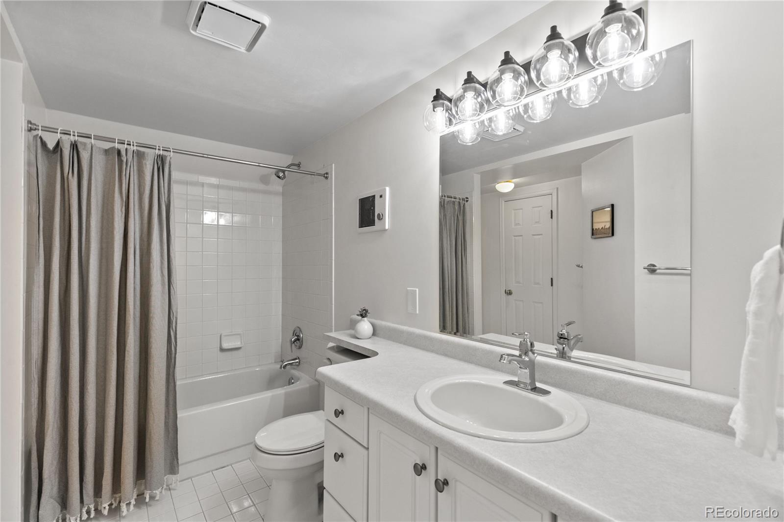 9362 Cornell Circle Highlands Ranch, CO 80130 - Photo 39 of 44 a bathroom with a granite countertop sink toilet and shower