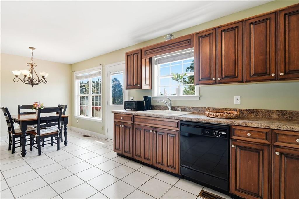 103 Denali Drive Calhoun, GA 30701 - Photo 20 of 39 a kitchen with granite countertop a sink cabinets and window