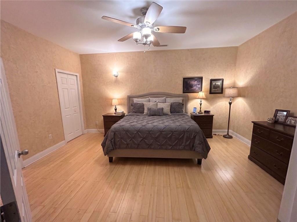 103 Denali Drive Calhoun, GA 30701 - Photo 32 of 39 a bedroom with a bed and wooden floor