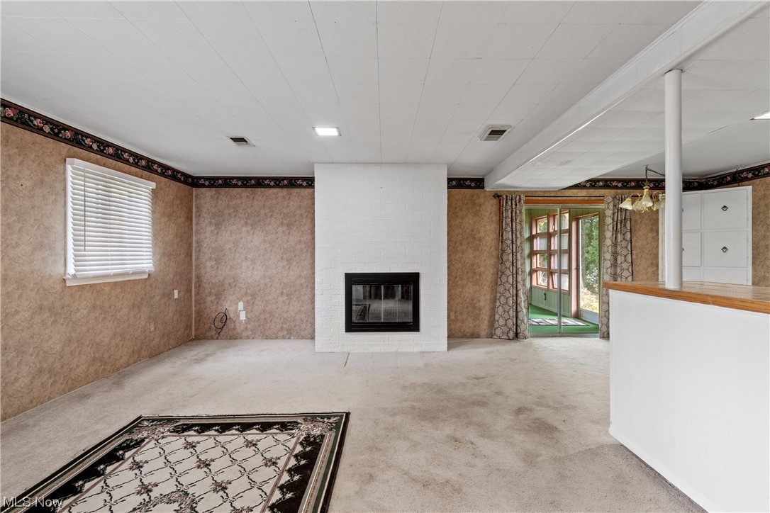 120 Lester Road New Franklin, OH 44319 - Photo 10 of 24 Carpeted living room with a fireplace