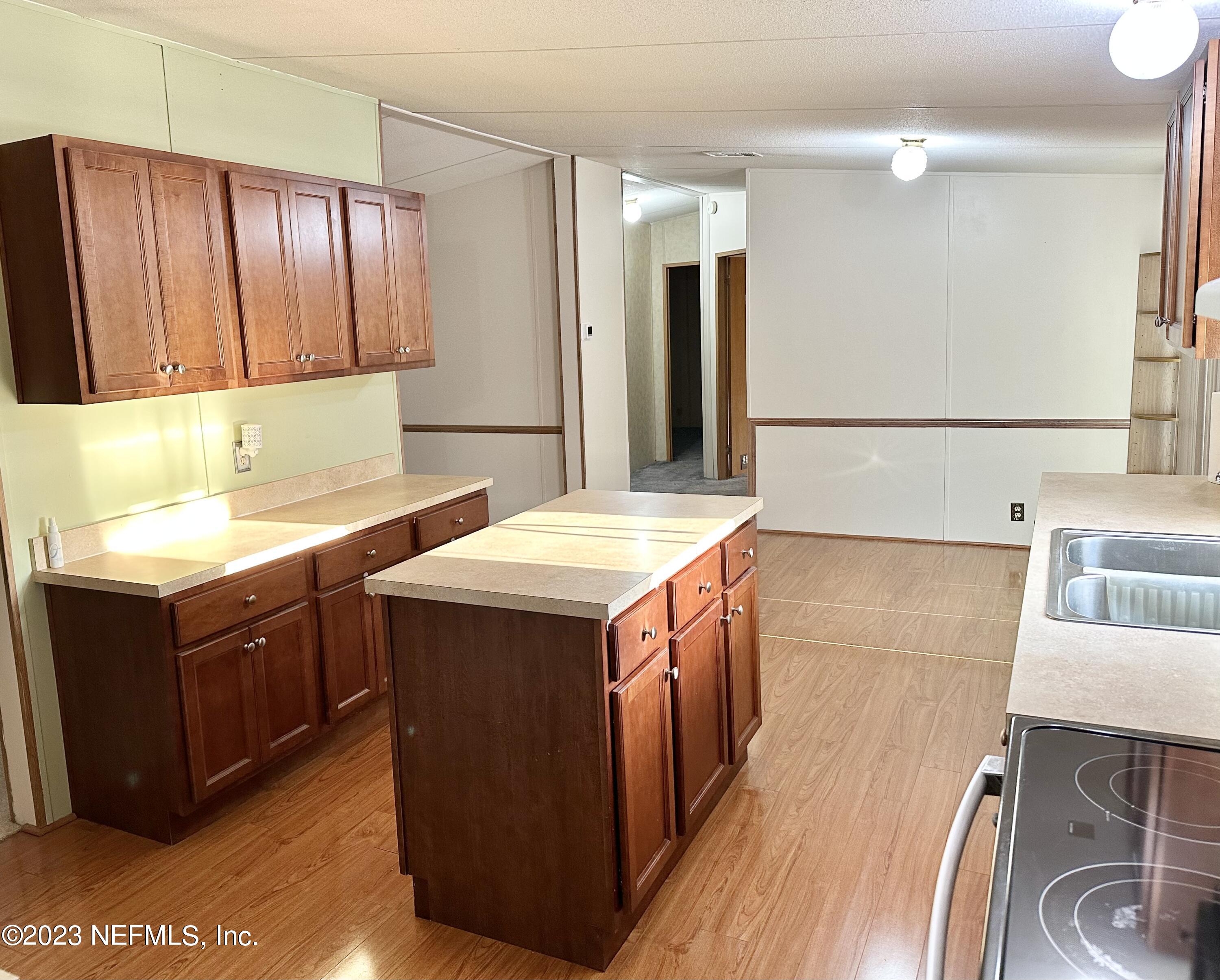 15644 Sears Road Jacksonville, FL 32218 - Photo 12 of 24 a kitchen with stainless steel appliances granite countertop a sink stove and refrigerator