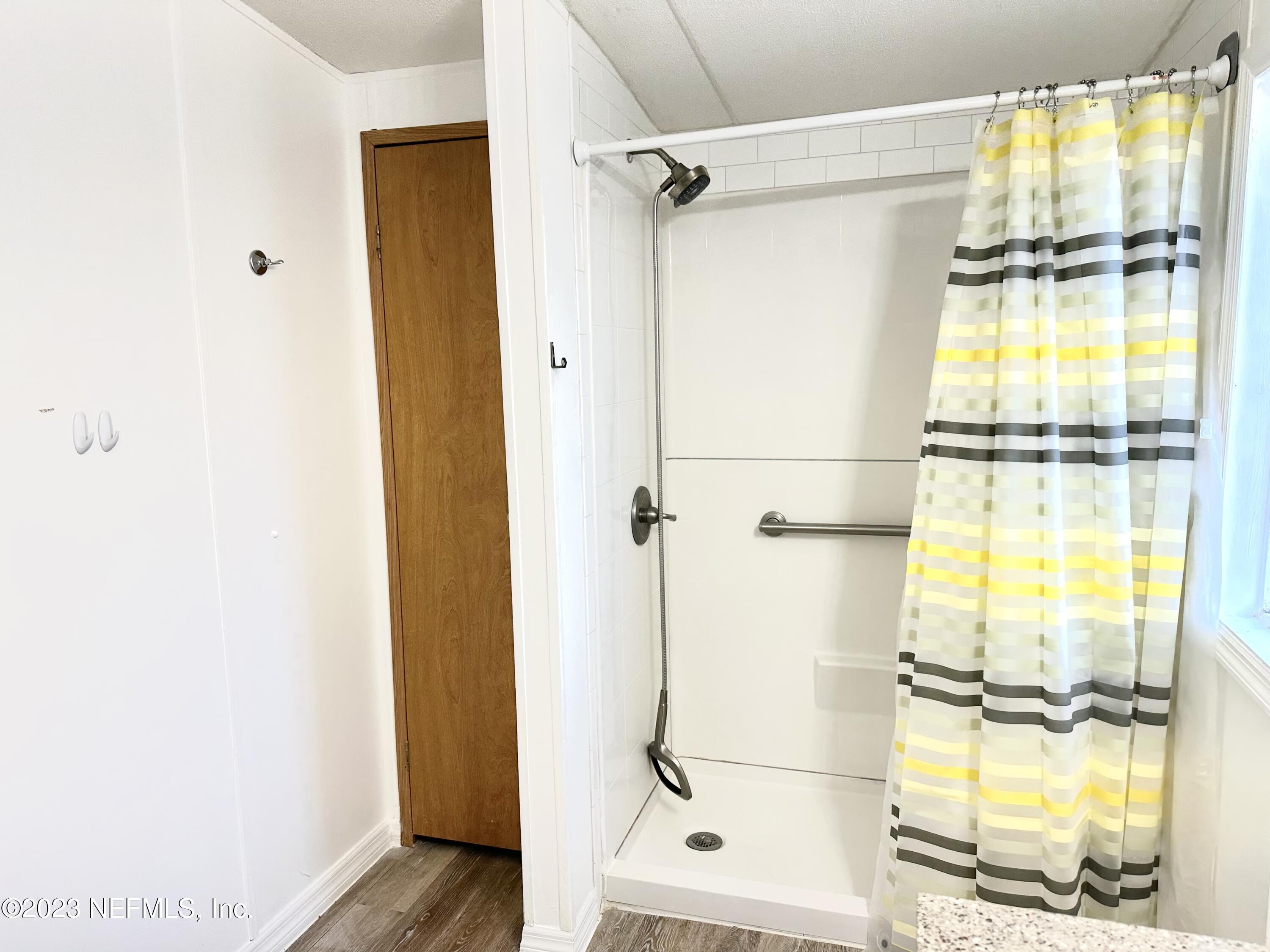 15644 Sears Road Jacksonville, FL 32218 - Photo 22 of 24 a bathroom with a glass shower door