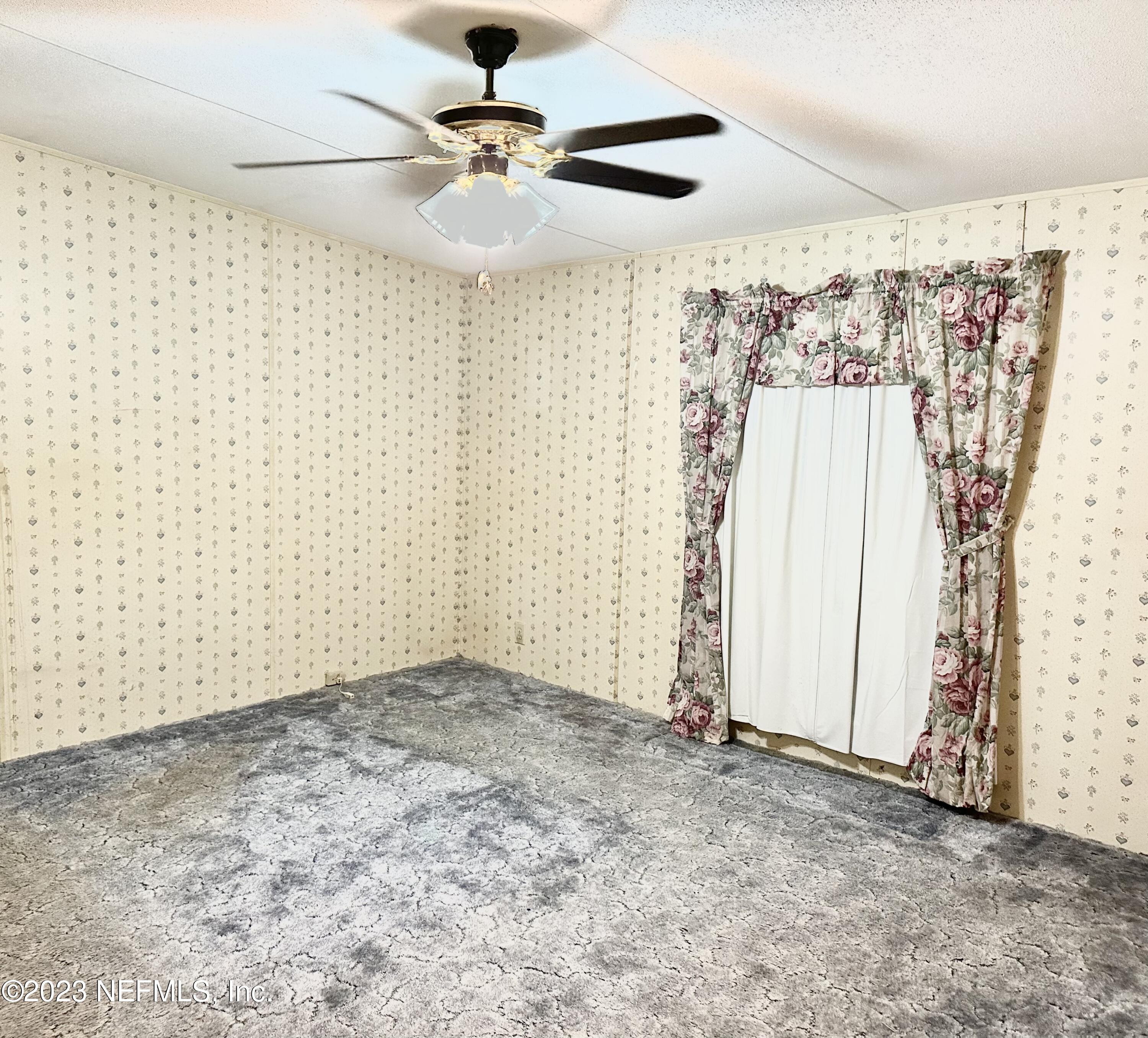 15644 Sears Road Jacksonville, FL 32218 - Photo 23 of 24 a view of a livingroom with a ceiling fan and a window