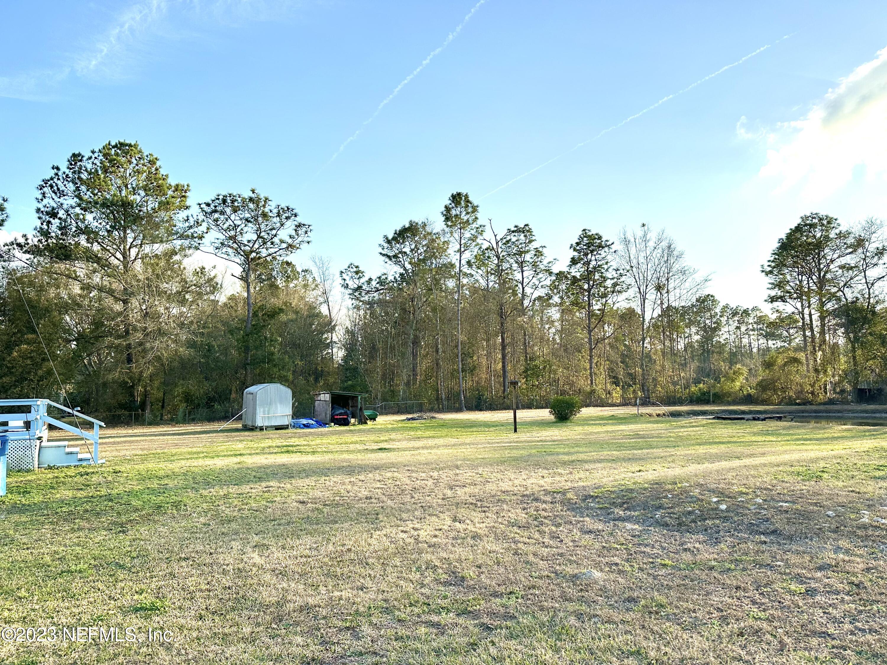 15644 Sears Road Jacksonville, FL 32218 - Photo 6 of 24 a view of a big yard with palm trees