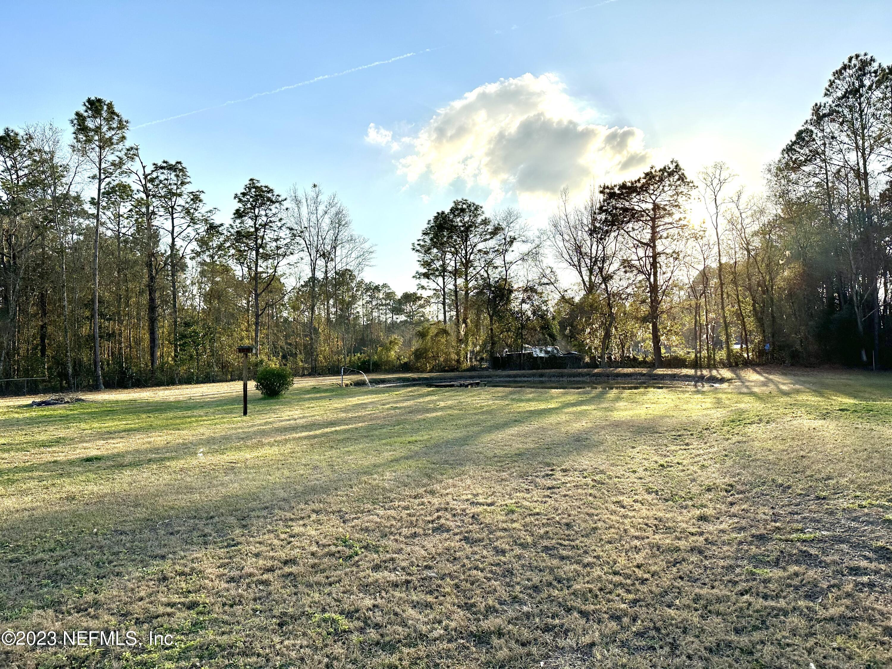15644 Sears Road Jacksonville, FL 32218 - Photo 8 of 24 a view of a yard with trees