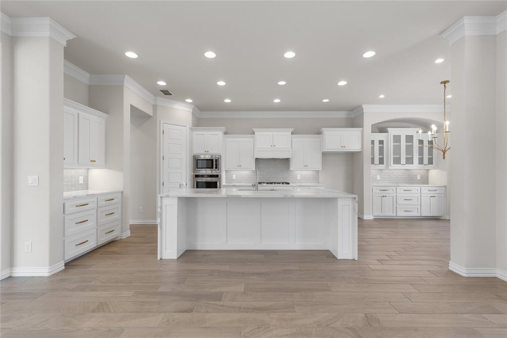 5682 Blackstone Drive Wichita Falls, TX 76310 - Photo 13 of 31 a large white kitchen with lots of counter space wooden floor and appliances