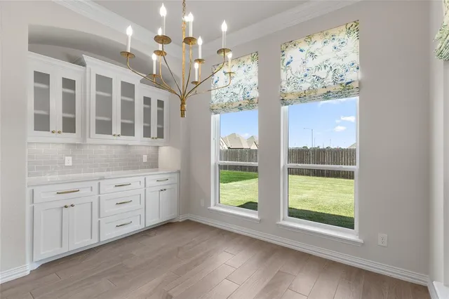 a spacious bathroom with a granite countertop sink mirror and large window