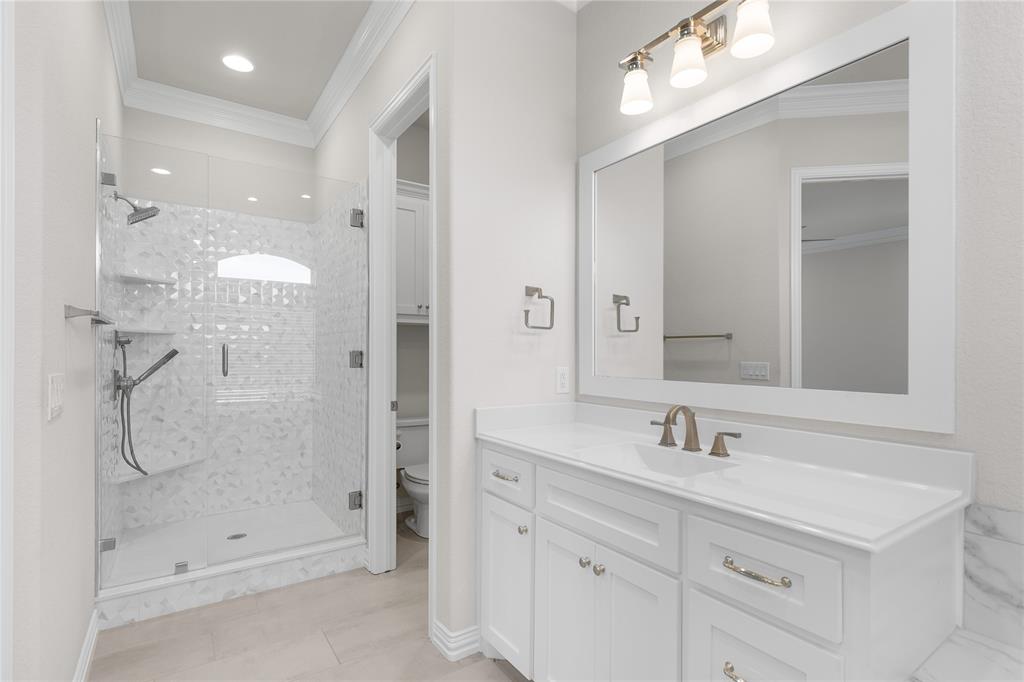 5682 Blackstone Drive Wichita Falls, TX 76310 - Photo 25 of 31 a bathroom with a shower sink double vanity and mirror