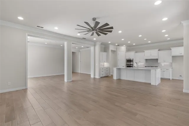 a view of a kitchen with a sink and a refrigerator