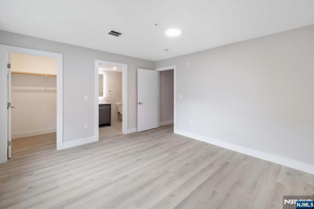 526 64th Street, Unit 3 West New York, NJ 07093 - Photo 13 of 19 an empty room with wooden floor & windows and bathroom