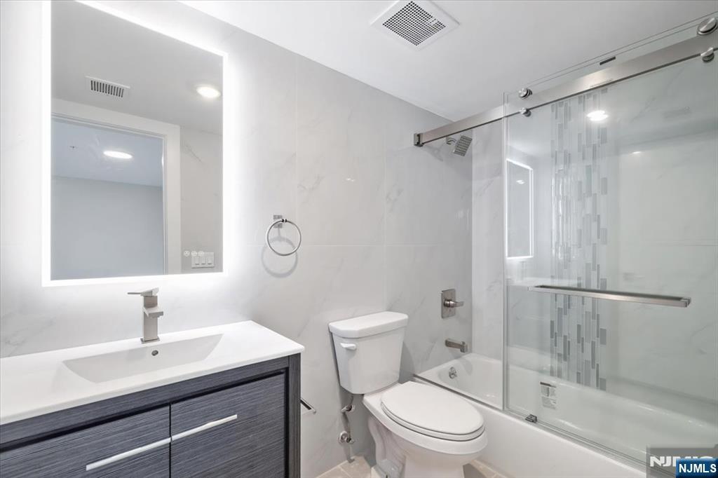 526 64th Street, Unit 3 West New York, NJ 07093 - Photo 10 of 19 a bathroom with a sink toilet vanity and shower