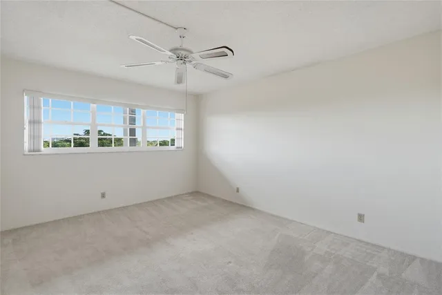 a view of a kitchen with an empty space and a window