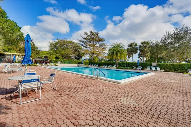 a view of a cars park in front of a building