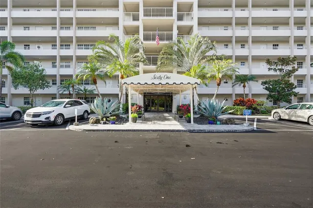 a front view of a house with potted plants