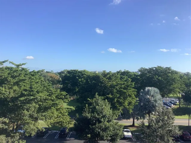 a view of a city with lush green forest