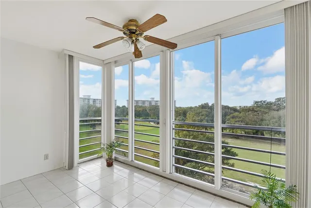 a view of a livingroom with a ceiling fan and window