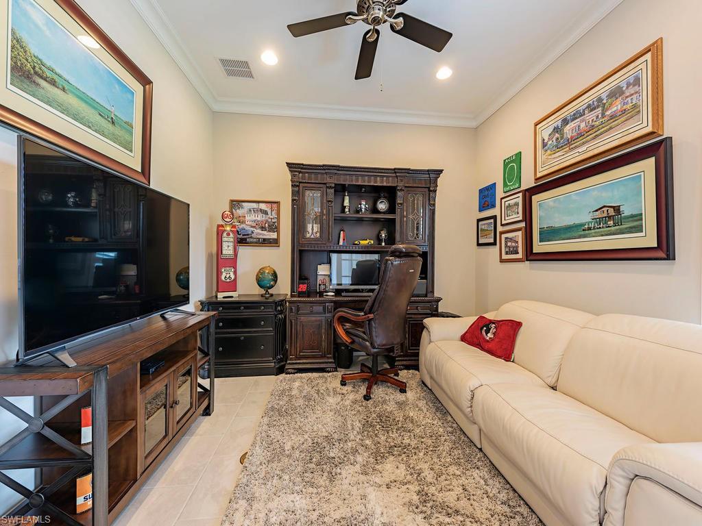 16211 Marsilea Place Naples, FL 34110 - Photo 13 of 17 a living room with furniture and a flat screen tv