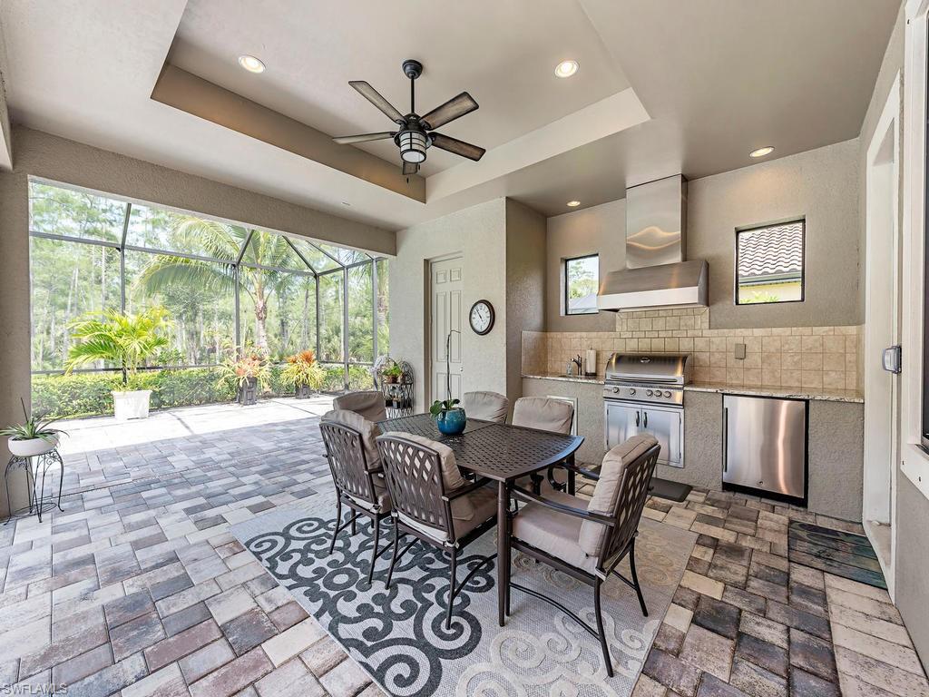 16211 Marsilea Place Naples, FL 34110 - Photo 14 of 17 a view of a dining room with furniture window and outside view