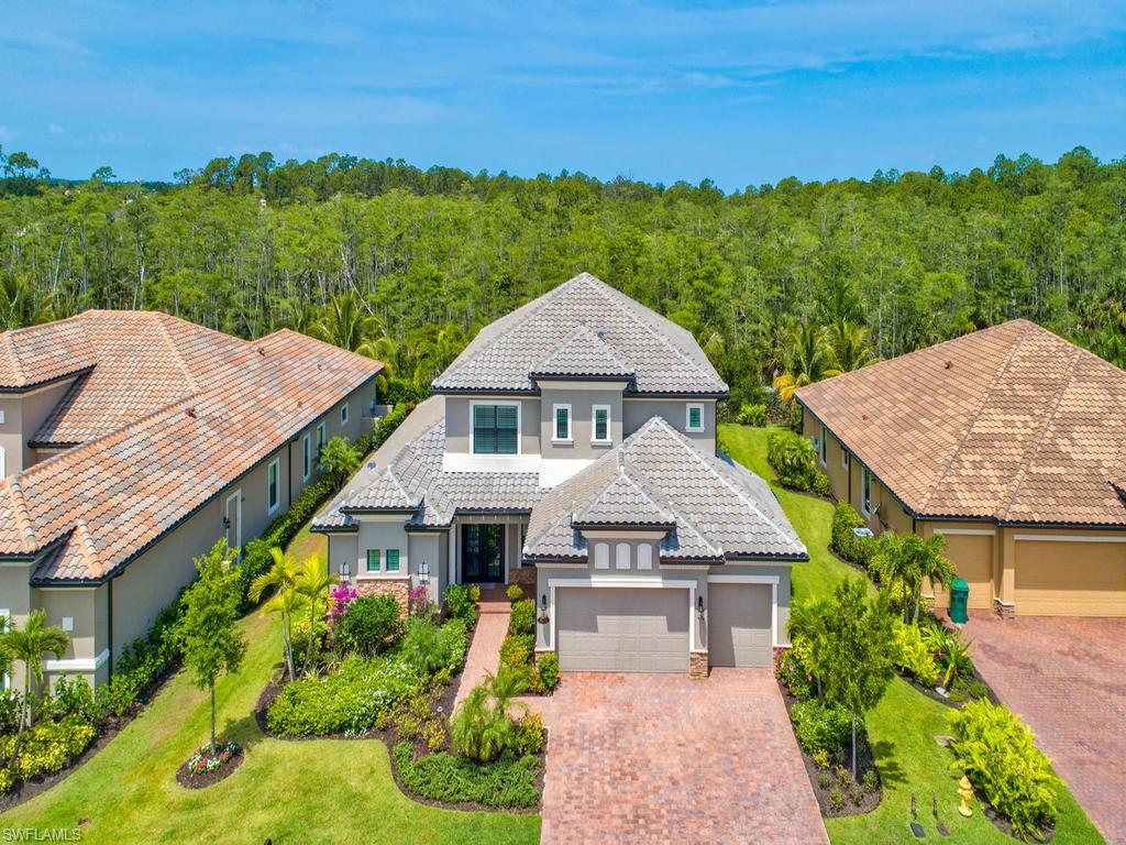 16211 Marsilea Place Naples, FL 34110 - Photo 2 of 17 a aerial view of a house with a garden