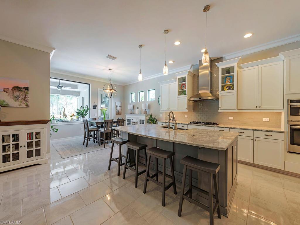 16211 Marsilea Place Naples, FL 34110 - Photo 6 of 17 a large kitchen with a large counter top furniture a sink and appliances