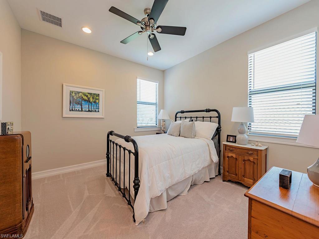 16211 Marsilea Place Naples, FL 34110 - Photo 9 of 17 a bedroom with furniture and windows