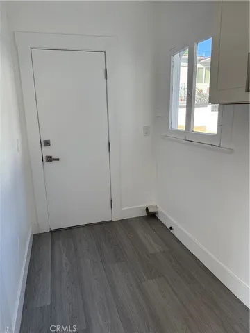 a kitchen with white cabinets and appliances
