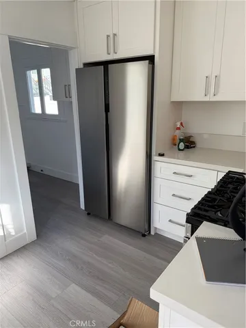 a kitchen with a refrigerator and a stove