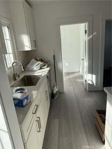 a kitchen with sink cabinets and stainless steel appliances