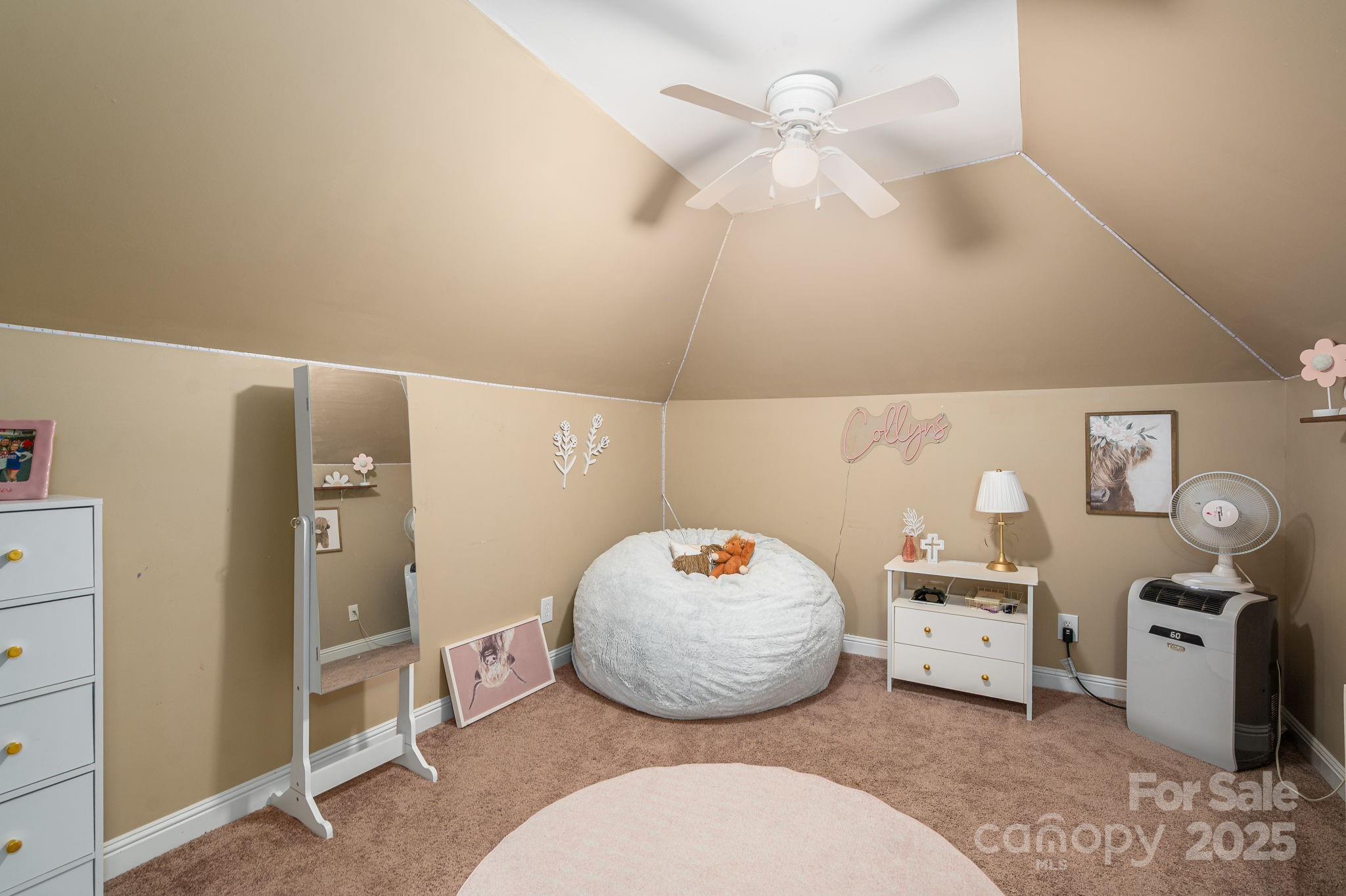 543 Roy Eaker Road Cherryville, NC 28021 - Photo 25 of 43 a bedroom with a bed and a chandelier